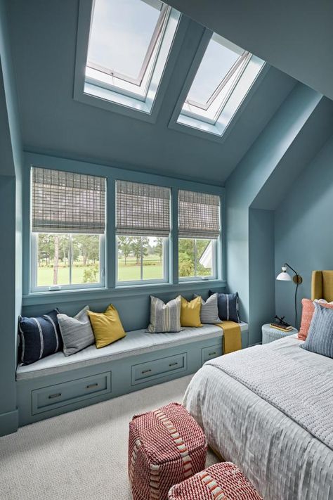 A pair of solar-powered fresh air skylights and large windows enhance the size of the blue guest bedroom on the second floor. Room darkening double-pleated solar shades on the skylights block the light so guests can sleep in on lazy weekend mornings. Skylight Above Bed, Sky Window Bedroom, Sky Light Window, Bedroom Skylight, Sky Blue Bedroom, Blue Guest Bedroom, Skylight Bedroom, Sun Tunnels, Smart Storage Ideas