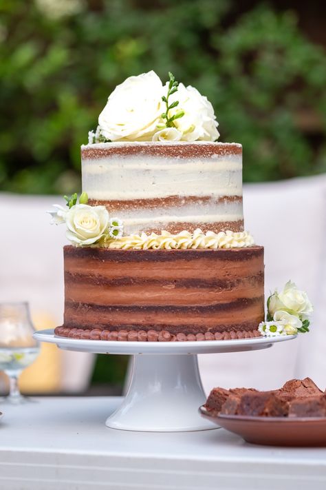 Semi-naked cake, with a bottom tier made of chocolate sponge and chocolate buttercream, and a top tier made of lemon sponge and lemon buttercream. The client wanted pretty and elegant, white and green flowers, to remind her of a quintessential English garden - we chose Roses, Freesias and Daisies Chocolate And Vanilla Tiered Cake, Chocolate And Vanilla Wedding Cake, Brownie Wedding Cakes, Sponge Wedding Cake, Naked Chocolate Cake, Stacked Cake, White And Green Flowers, Wedding Cake Vanilla