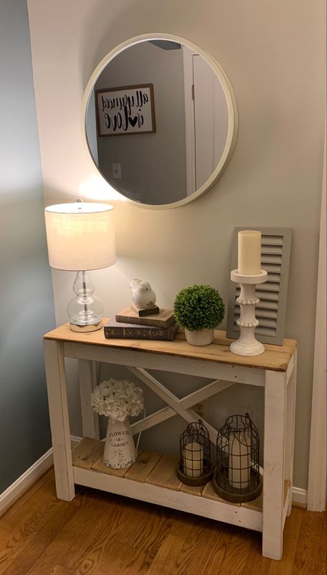 I decorated my small entryway space using a rustic console table and Wayfair, TJ Maxx, Target, and Dollar General decor finds. The table itself was purchased from the Cincinnati Open Box Outlet for $80, which is an awesome place to get cheap furniture! It was inexpensive and I only have about $150 in the everything including the table and wall mirror. I shopped clearance items and used coupons for all my purchases. It’s amazing what you can do for so little money! Doorway Table Decor, Mirror Buffet Decor, Rustic Console Tables Entryway, Small Table Entryway Decor, Small Entryway Table Decor Farmhouse, Small Hallway Table Decor, Small Foyer Table Decor, Diy Small Console Table, Small Table Decor Ideas