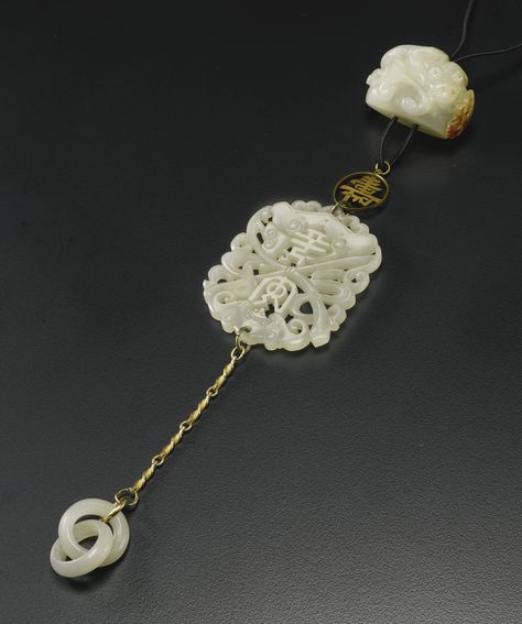 A CELADON JADE PENDANT  QING DYNASTY comprising three elements; a pebble form carving of a chilong coiled around a lingzhi; an openwork plaque with a bat, chime and the characters ping an and two interlocking rings Qing Dynasty Jewelry, Blue Apatite Jewelry, Apatite Jewelry, Interlocking Rings, Antique Jade, Chinese Jewelry, Chinese Jade, Carved Jade, Ancient Jewelry