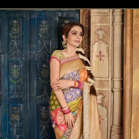 MANISH MALHOTRA on Instagram: "The graceful Mrs. Nita Ambani honours India’s rich cultural heritage with a spectacular reimagining of the holy city of Varanasi at Anant Ambani and Radhika Merchant’s wedding, draped in our custom Rangkat saree. She epitomised the timeless elegance of Varanasi with a breathtaking 28 chauk jaal Rangkat saree, adorned with intricate floral motifs and vibrant real zari. This special ensemble, designed and styled by @manishmalhotra05 in collaboration with @swadesh_online, serves as yet another homage to the extraordinary craftsmanship of India’s master artisans. The saree took six months to weave, with only a select few Banarasi weavers possessing the expertise to craft an authentic Rangkat saree.

@nmacc.india 
@swadesh_online 

Drape Artist: @dolly.jain 
Make- Nita Ambani, Hair Photography, Manish Malhotra, Varanasi, Fancy Sarees, Celebrity Weddings, Timeless Elegance, Saree