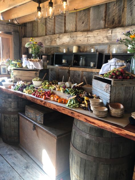 Vegetables and crackers displayed on a wooden table in a rustic barn setting Wooden Buffet Table Food Displays, Rustic Buffet Table Food Stations, Rustic Wedding Food, Rustic Catering, Rustic Food Display, Rustic Buffet Table, Wedding Snack Bar, Restaurant Remodel, Wedding Charcuterie