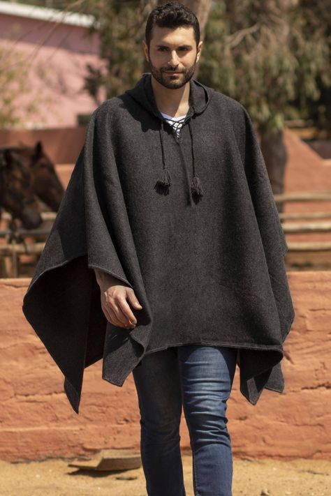 By Celinda Jaco this handsome graphite grey poncho features an attached hood and a drawstring at the neck. The Peruvian artisan works in a cozy blend of luxurious alpaca renowned for its lightweight warmth. Open at the sides for ease of movement this fashion accessory goes from informal to dressy with ease. Men’s Poncho, Poncho Outfit Men, Poncho Reference, Ranger Uniform, Poncho For Men, Peruvian Poncho, Poncho Hoodie, Poncho Men, Mens Poncho