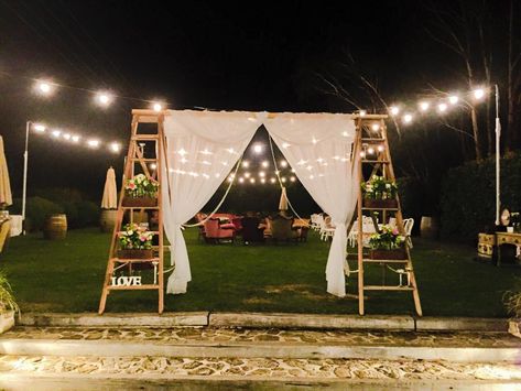 Ladder backdrop!  Another great way to decorate our ladder arbour. This was from a wedding we styled at Goldings Winery, used to walk through from the ceremony to reception. Curtains and crystals draped in the opening and wooden sewing machine boxes with flowers on the steps. Ladder Wedding, Event Entrance, Flower Backdrop Wedding, Orchard Wedding, Rustic Vintage Wedding, Wedding Arbour, Wedding Ceremony Backdrop, Garden Wedding Decorations, Wedding With Kids