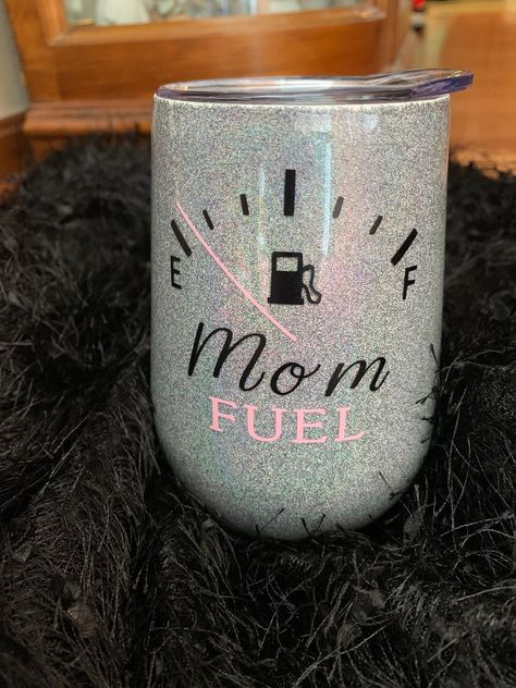 Mom Fuel wine tumbler is a stainless steel, epoxy coated, 12 oz wine tumbler. It is covered with holographic silver glitter and available in multiple other holographic glitter colors. This makes for a cute mother's day gift or birthday present that a tired mom would love! The multiple layers of epoxy seal the glitter and vinyl to give a smooth, glossy, and protective finish. This tumbler is safe to use with hot and cold drinks and the epoxy adds to the insulation, keeping drinks hot and cold for Wine Tumbler Gift Set, Glitter Wine Tumbler Ideas, Wine Glass Tumbler Ideas, Funny Mom Tumbler Cups, Grandma Tumbler Ideas, Wine Cups Vinyl Ideas, Tumbler Ideas For Moms, Mom Tumbler Ideas, Mothers Day Tumblers