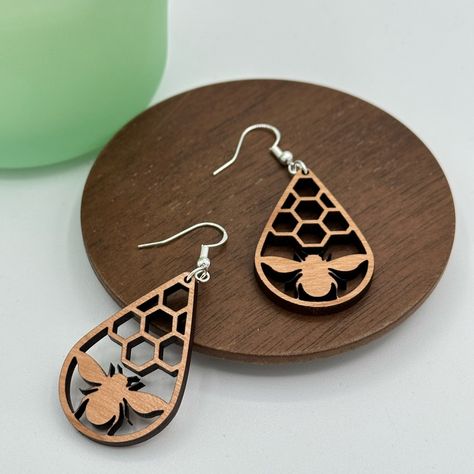 These Fun Bee Honeycomb Earrings Are Handmade Here In Our Shop At Gemini Creative. Laser Cut From Cherrywood And Paired With 925 Sterling Silver Findings. Wood Teardrop Measures Approximately 1 1/2”. Bundle Any 5 Pairs Of Gemini Creative Earrings And Receive 25% Off. Just Bundle And Offer, I Will Accept. Message Me If You Would Like Multiples Of The Same Earring And I’ll Make You A Custom Bundle. Laser Cut Jewelry Wood, Lazer Cut Wood, Glowforge Earrings, Acrylic Earrings Laser Cut, Laser Cut Bracelet, Laser Earrings, Honeycomb Earrings, Laser Jewelry, Laser Cut Wood Jewelry