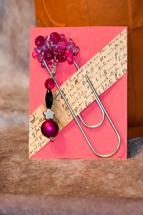 Elevate your reading experience with this Metal Paperclip Bookmark adorned with charming beads and a chain with a silver star focal point. This large 4-inch paperclip features shades of pink and purple for a whimsical touch. Perfect for junk journals, books and planners. Add personality to your books and journals with our Paperclip Charms featuring a unique blend of black and purple beads. The attached chain holds a stunning silver star, making it a standout accessory for your planner or bookmark. Paperclip Charms, Diy Happy Planner, Star Making, Crafts Corner, Paperclip Bookmarks, Unique Planner, Planner Bookmark, Purple Beads, Book Marks