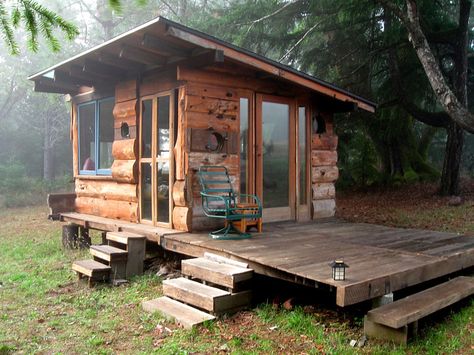 Cabin deep in the woods of Northern California. Spring water and solar power and scavenged wood and antique portholes from real ships - from Tiny House Swoon Small Cabin In The Woods, Design Case Mici, Off Grid Tiny House, Tiny House Swoon, Wooden Cabin, Cabin Tiny House, House Cabin, Tiny Cabins, Little Cabin