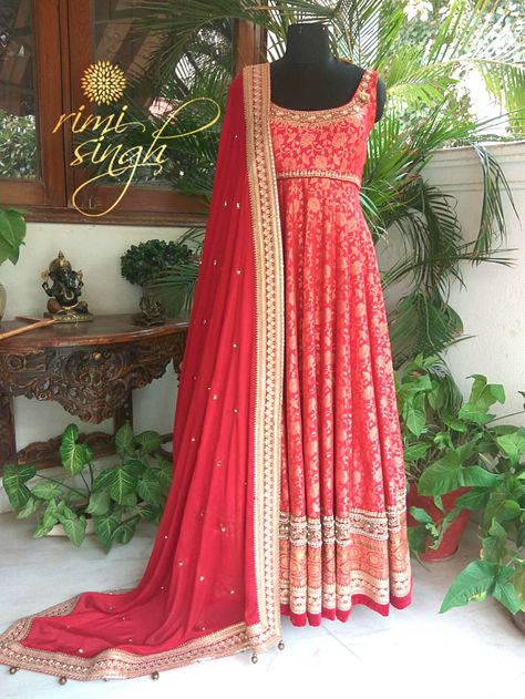 Vermillion red banarasi silk anarkali with hand embroidery on the neckline , waist and ghera teamed with a matching chinnon chiffon dupatta . There is dori and sitara embroidery along with a banarasi border on the  gher, and on the four sides of the dupatta. Banarasi Anarkali Dress, Banarasi Anarkali Suits, Red Anarkali Suits Wedding, Red Banarasi Suit, Banarasi Silk Anarkali Suits, Banarasi Anarkali, Red Anarkali Suits, Silk Anarkali Suits, Kalamkari Dresses