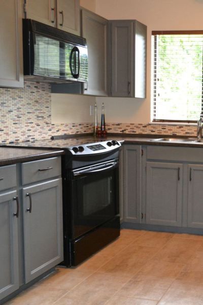 how to decorate a kitchen with black appliances and benjamin moore chelsea gray painted oak cabinets. Update ideas Gray Kitchen Countertops, Distressed Kitchen Cabinets, Black Appliances Kitchen, Painting Oak Cabinets, Dark Countertops, Black Appliances, Grey Countertops, Gray Cabinets, Grey Kitchens