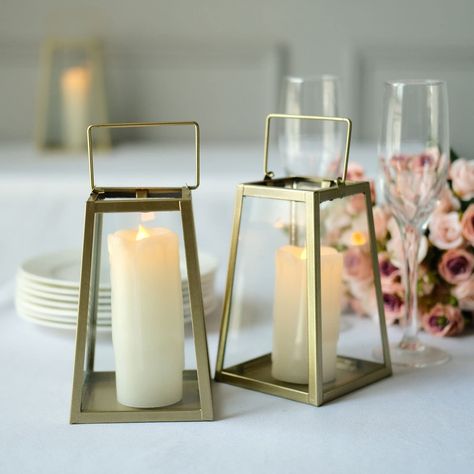 PRICES MAY VARY. Gold Metal Candle Lantern Add some warmth and ambiance to your home or event with our stunning Trapezoid Metal Candle Lanterns. These stunning lanterns are made of sturdy metal and feature a modern trapezoid shape and a contemporary appeal. The high-quality lantern candle holders have a gold metal finish with clear glass panels, making them perfect for any party or interior décor.   Lantern Candle Holder The Metal Candle Lanterns are perfect for any special occasion or event. Wh Metal Candle Lanterns, Geometric Candle Holder, Hanging Candle Lanterns, Geometric Candles, Trapezoid Shape, Hanging Terrarium, Lantern Candle, Lantern Candle Decor, Candleholder Centerpieces