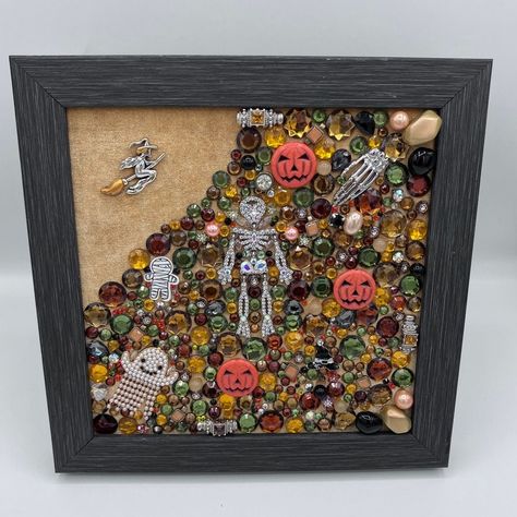 Jack-o'-lanterns, skeletons and ghosts in a mosaic of rhinestones and beads. Black wood 9 1/2 x 9 1/2 inch frame with various Halloween themed brooches, earring pieces and charms accented by faux pearls, rhinestones, topaz colored bracelet pieces, glass beads and other. Halloween Jewelry Art, Bead Mosaic, Jewelry Collage, Jewelry Repurposed, Halloween Scene, Crafts Kids, Topaz Color, Fall Projects, Button Crafts