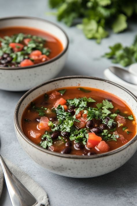 Warm up with a bowl of comforting Cuban Tomato and Black Bean Soup. This hearty soup is packed with robust flavors and wholesome ingredients, making it the perfect dish for cozy nights in or gatherings with friends. The combination of juicy tomatoes, earthy black beans, and aromatic spices will tantalize your taste buds and keep you coming back for more. Whether you're a seasoned cook or new to the kitchen, this recipe is easy to make and sure to impress. Soup With Kielbasa, Black Bean Soup Recipe, Tomato Soup Homemade, Bean Soup Recipes, Hearty Soup, Black Bean Soup, Tomato Soup Recipes, Smoked Ham, Juicy Tomatoes