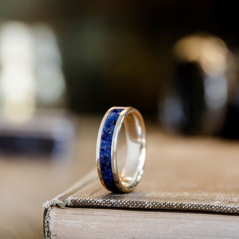 Named after the mythological Titan, tasked with holding the heavens in place, The Atlas men's silver wedding band embodies a spirit of strength, steadfastness, and exploration. With a single inlay of striking lapis lazuli, this silver ring design is perfect for the man who appreciates simple yet distinctive design that showcases his unwavering devotion to the love of his life.  Lapis Lazuli & Silver Ring Features:  SCS certified 100% recycled silver ring base  Authentic hand-ground raw lapis Lapis Lazuli Rings For Men, Mens Silver Wedding Bands, Raw Lapis Lazuli, Silver Ring Design, Black Titanium Ring, Western Rings, Ring Upgrade, Rustic Wedding Bands, Wedding Ring Sets Unique