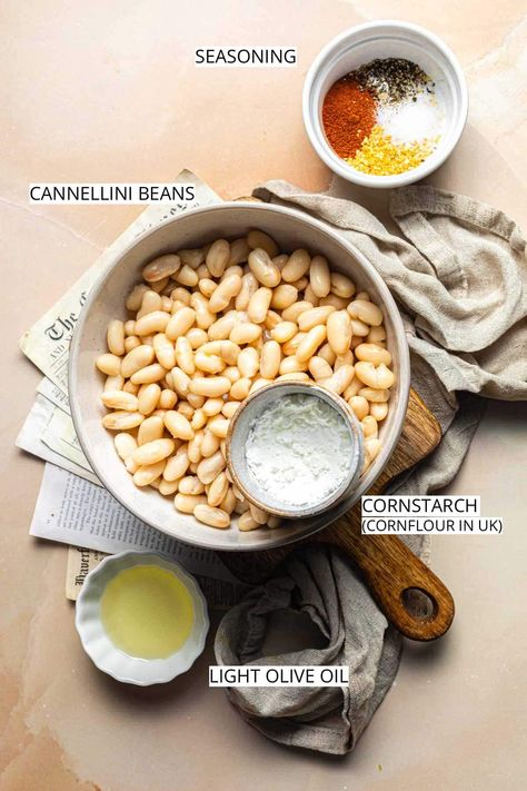 Roasted cannellini beans are a crispy, fiber-rich snack made in just over half an hour. Find out how we turn these creamy white beans into a satisfyingly crunchy snack. This roasted cannellini beans recipe uses pantry staples that you probably already have in your kitchen cupboard. You can serve them as part of your main dish, eat them as a snack or a side. Hint - Think of the seasoning as more of a suggestion rather than a hard rule. If desired, feel free to use your other favorite herbs. Crispy White Beans, Roasted Lentils, Cannellini Beans Recipes, Creamy White Beans, Vegan Minimalist, Cold Snack, Plant Based Snacks, Stewed Potatoes, Crunchy Snack