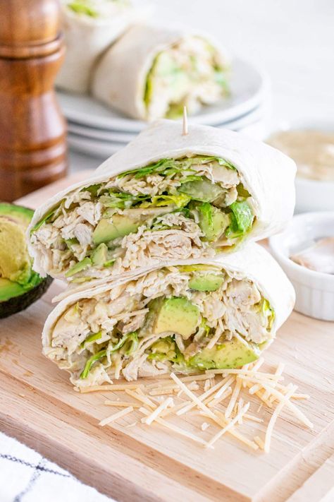 This simple and speedy lunch (just 20 minutes to make) is sure to become something you want to enjoy time and time again. Soft wraps are loaded up with chicken, lettuce, avocado, parmesan, and a rich and creamy Caesar dressing. If you're really pressed for time, you can use a store-bought Caesar salad dressing instead for equally tasty results. This is a nice recipe if you have leftover rotisserie chicken to use up. I like to add a little anchovy paste to the dressing for an extra-special taste. Avocado Wrap Recipes, Wraps With Avocado, Chicken Caesar Wrap Recipe, Recipes Using Cooked Chicken, Chicken Caesar Salad Wraps, Caesar Salad Wrap, Creamy Caesar Dressing, Anchovy Paste, Chicken Caesar Wrap