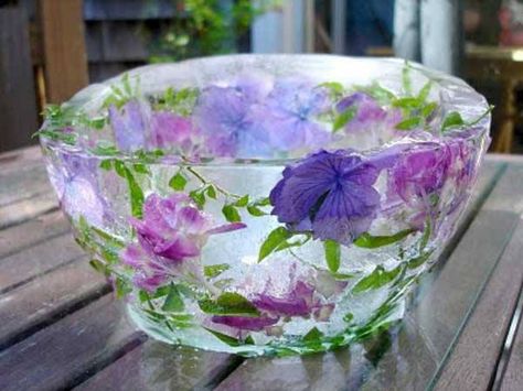 Floral Ice Bowl Instructions: fill a bowl 3/4 full of water, add flowers, petals, herbs, leaves, berries... whatever you want to decorate it with. Place a smaller bowl inside to create a void and displace water to fill the larger bowl. You can duct tape the bowls together to keep them centered. Freeze over night. Remove and leave at room temperature for 10-15 minutes to loosen the ice bowl. Refreeze the ice bowl alone until ready to use. Very simple! By Whimsical Gardens Deco Fruit, Plastic Mixing Bowls, Ice Bowl, Floral Ice, Flower Ice, Diy Bowl, Deco Floral, Edible Flowers, Diy Wedding Decorations