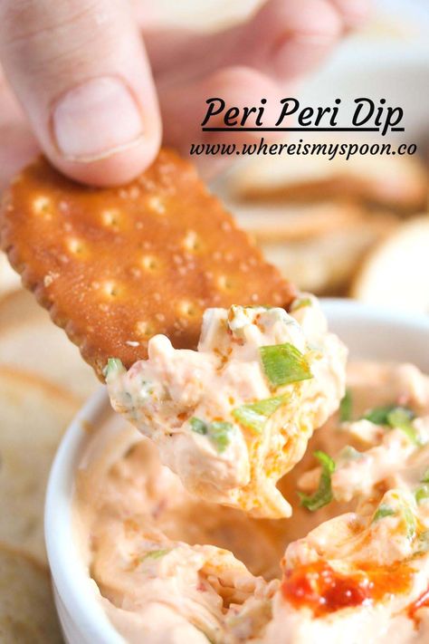 Child's hand dipping a cracker in peri peri dip with cream cheese and green onions. Recipes Using Peri Peri Sauce, Spicy Cream Cheese Dip, Spicy Cheese Dip, Spicy Pretzels, Cold Dip, Dip With Cream Cheese, Cream Cheese Recipes Dip, Cracker Dip, Cold Dips