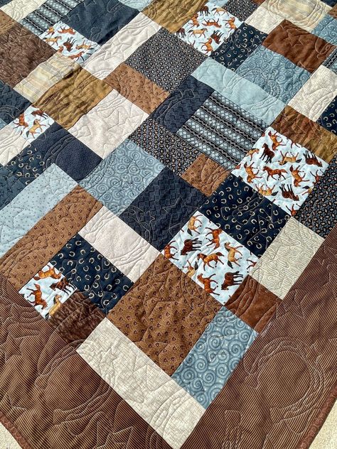 This quilt has a western flare with a horse print as the focal point and multiple coordinating fabrics in shades of blue, brown and tan...all 100% quilt shop quality. This oversized quilt, measuring 65 inches by 91 inches would be great to cuddle under, and also fits a twin-sized mattress. The backing fabric is 100% cotton with tan swirls. The binding is a coordinating brown print and secured with a machine stitch to ensure that it will hold up to years of use and multiple washings. The machine Country Quilt Patterns, Western Quilt Patterns, Stuco Posters, Twin Bed Quilt, Western Quilts, Cowboy Quilt, Country Quilt, Oversized Quilt, Horse Quilt