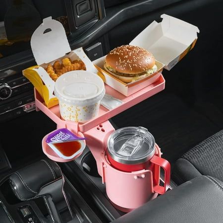 The equipped hole on the 10'' wide tray could contain an extra fast food cups. The cellphone can be placed on the slot and let the charge cable through the hole of it. When not in use, you can kindly spin the tray in 360 stable rotation to fit your position. Joytutus large cup holder adapter for car adopts the OFF-SET long base design, which perfectly fits for more different types of original car cup holders. It is compatible with the gear shifter, center console lid, car dash and allows two cup Pink Car Accessories, Car Food, Cute Car Accessories, Car Hacks, Pink Accessories, Pink Car, Truck Design, Car Personalization, Food Trays