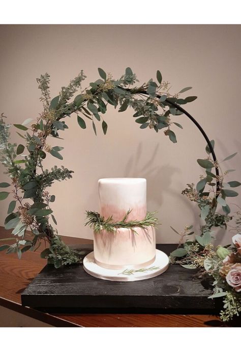 Elegant and simple two-tier wedding cake with a dusky pink and taupe colour wash and fresh rosemary garland.  Displayed on a hoop cake stand, dressed with fresh foliage  #duskypinkwedding #pinkweddingcake #taupewedding #cakedisplayideas #rusticweddingcake Rosemary Garland, Cake Hoop, Cake Stand Centerpiece, 25 Anniversary Cake, Cake Displays, Taupe Wedding, Wedding Cake Display, Pink Wedding Inspiration, Taupe Colour