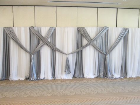 Thirty foot back drop in white and silver by Tanis J Events. www.tanisjevents.com Diy Draping, Head Table Wedding Backdrop, Wedding Backdrop Lights, Pvc Backdrop, Draping Wedding, Diy Wedding Arch, Reception Backdrop, Diy Wedding Reception, Wedding Reception Backdrop