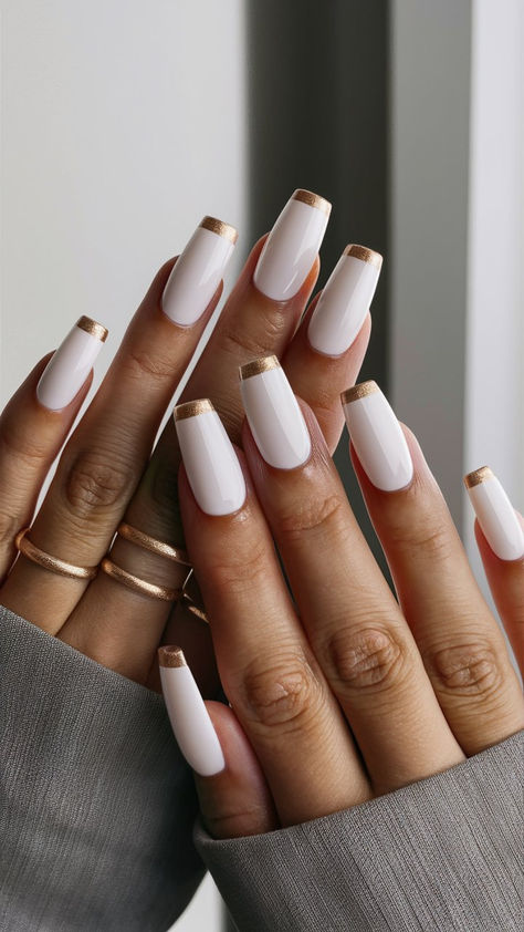 Elevate your nail game with this stunning white manicure featuring luxurious gold tips! This eye-catching design combines a crisp, clean base with a touch of glamour, making it perfect for both casual outings and special events. The gold accents add a modern twist, creating a look that’s effortlessly chic. Get inspired to shine bright with this elegant nail art! 🌟 White Nails With Gold Tips, White Nails With Gold Design, Cream And Gold Nails, Nails With Gold Tips, Elegant White Nails, Gold White Nails, White Gold Nails, Color Trends 2024, White Nails With Gold