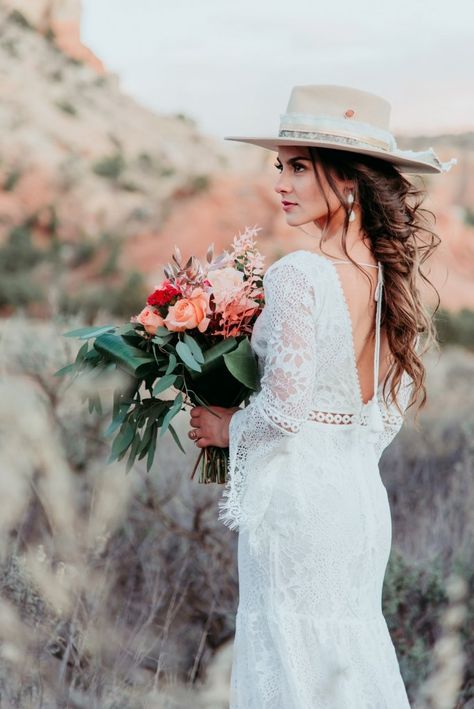 Elopement Dresses Guide Cheap Wedding Dress Options for Elopements | https://wanderingweddings.com/elopement-dresses/ Hats With Wedding Dresses, Boho Wedding Hair Hat, Bridal Hat Boho, Wedding Dress With Wide Brim Hat, Wedding Dress And Cowboy Hat, Wedding Dresses With Hats, Wedding Dress With Hat Boho, Wedding Cowboy Hats For Bride, Bridal Hair With Hat