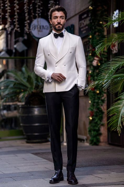 Flaunt your luxurious charm with the White Slim-Fit Tuxedo 3-Piece. The elegant white color and meticulously tailored fit offer a look of pure sophistication and class. Perfect for grand events and special occasions, this tuxedo guarantees you’ll make a stunning impression, exuding confidence and style.  #doublebreasted #whitetuxedo #tuxedo #suit #suits #slimfit #menstyle #menfashion #fashioninspo 3piece Suit Men, White Tuxedo For Men, 1920s Tuxedo, Fat Men Outfit, Bow Tie Suit, Modern Fit Suit, Suit Styles, Double Breasted Tuxedo, Suit Stores