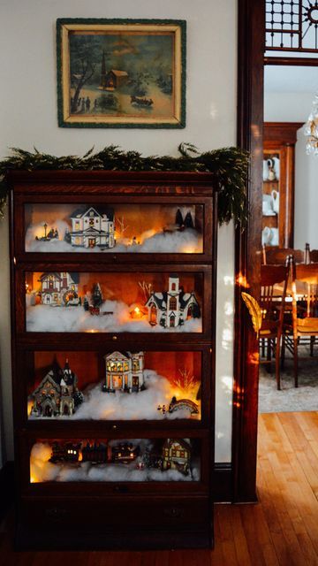 Courtney Vettel | The Vettel Farm on Instagram: "Once you see it, you can’t unsee it 😉 Hands down the most fun and unique way to display a Christmas village! Search your Facebook Marketplace, antique stores, thrift shops for a lawyer’s cabinet or barrister’s bookcase, you won’t regret it. #vintagechristmas #christmasvillage #christmasdecorations #barristerbookcase #christmastown #victorianchristmas" Holiday Village Display, Victorian Christmas Decorations, Bookcase Decor, Christmas Village Display, Holiday Village, Christmas Room Decor, Christmas Town, Christmas Inspo, Old Christmas