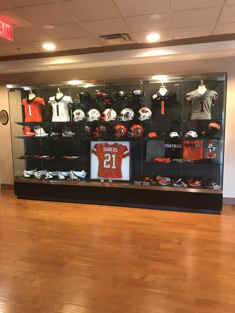 Sports Memorabilia Display Wall, Sports Memorabilia Display Wall Man Cave, Football Helmet Display Ideas Man Caves, Football Helmet Shelf Display, Football Helmet Wall Display, Football Helmet Display Cabinet, Sports Memorabilia Display, Trophy Cabinets, Basement Shelving