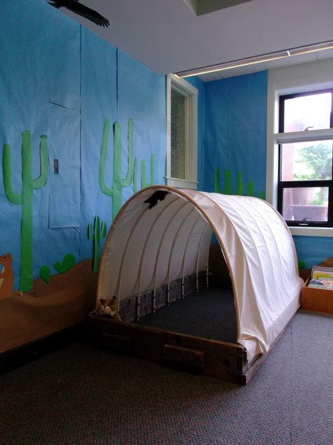 For our wild west theme, we created a covered wagon that kids can play in! Wild West Crafts, Western Classroom, Large Cactus, Desert Background, Cowboy Crafts, Wild West Theme, Wild West Party, Vbs Themes, Class Theme