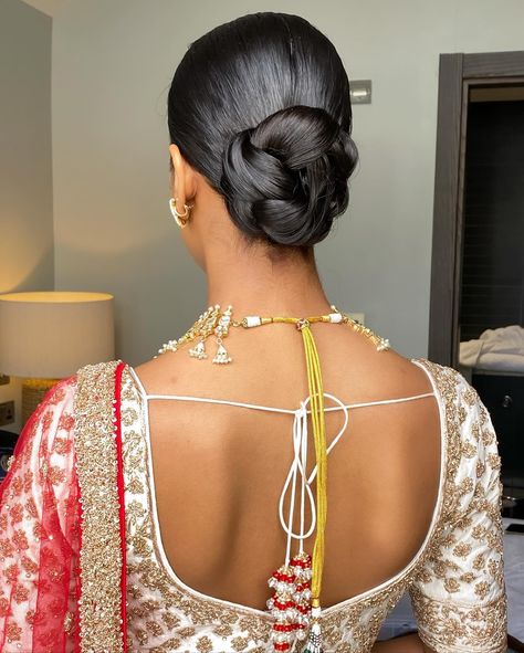 One of my favessss!! 🥨 Loved how elegant and sleek this was to go with the whole look for Shree’s wedding day Bridal makeup @_beautybyami Outfit @frontierraasuk Jewellery @thejewellerytrunk_ #weddinghair #wedding #bridalhair #bride #weddingdress #weddingmakeup #weddingphotography #weddingday #weddinginspiration #hair #bridalmakeup #updo #hairstylist #makeup #hairstyle #hairstyles #bridetobe #makeupartist #bridal #bridesmaids #weddings #love #weddinghairstyle #weddinghairstyles #weddingp... Sleek Bun Indian Wedding, Wedding Day Bun, Indian Wedding Hair Updo, Punjabi Bride Hairstyle, Indian Wedding Updo, Desi Bride Hair, Indian Bridal Updo, Indian Bridal Bun, Indian Updo