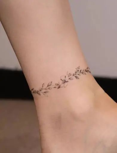 Anklet Flower Tattoo, Delicate Ankle Tattoo, Ankle Wrap Around Tattoo, Ankle Tattoos For Women Wrap Around, Ankle Wrap Tattoo, Arm Cuff Tattoo, Leg Tattoos For Women, Wrap Around Ankle Tattoos, Anklet Tattoos For Women