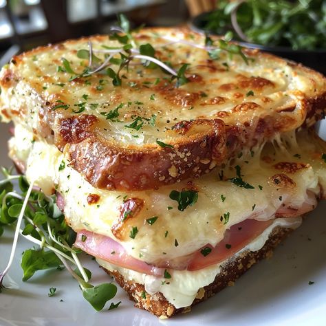 🥪🧀 Indulge in the Ultimate Croque Monsieur! 🍞✨ Enjoy a slice of French culinary heaven with this rich and cheesy Croque Monsieur. Layers of ham, Gruyère cheese, and creamy béchamel sauce toasted to perfection – it's the ultimate comfort food! 😋✨ Ingredients: White bread, butter, ham, Gruyère, Parmesan, Dijon mustard, parsley Béchamel sauce: Butter, flour, milk, nutmeg, salt, pepper Instructions: Prepare a smooth and creamy béchamel sauce. Assemble and toast the sandwiches. Top with bécham... Gourmet Ham Sandwich, French Ham Sandwich, Fresh Sandwich Ideas, Yummy Food Savory, Unique Sandwich Ideas, Cheese And Ham Sandwich, Dijon Butter, Croque Monsieur Recipe, French Meals