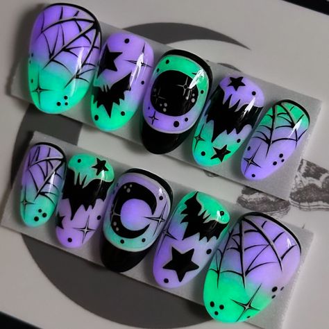 Who needs a flashlight when your nails are this lit? Shine on, spooky friends! 💚🦇✨💜 Witching Hour on Après Short Round 🥺💅🏻 ⁣ .⁣ .⁣ .⁣ .⁣ .⁣ #glowinthedarknails #glownails #lovebats #spiderwebnails #batsnails #spookyszn #boo #gothnailsofinstagram #halloweenmanicure #spookyseason #moonandstars #purplenails #shortnails #halloweennailsdesign #halloweennails #shortpressons #halloweennailart #spookynails #nailartist #pressonnailset #halloweenideas #glowinthedarknails💅 #happyhalloween #batnails #gl... Pastel Goth Nails Short, Hotel Transylvania Nails, Goth Nails Short, Pastel Goth Nails, Bat Nails, Cartoon Nails, Halloween Manicure, Spooky Nails, Cute Halloween Nails