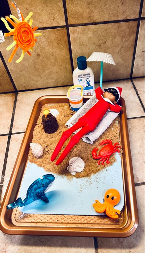 Elf enjoys a nice relaxing day on the beach working on his tan 🏝️☀️ Elf On Shelf Beach Ideas, Elf On The Shelf While On Vacation, Elf On The Shelf Cruise Ship, Beach Elf On The Shelf, Elf On The Shelf Beach, Elf On The Shelf Surfing, Elf On The Shelf Idea, Easy Elf On The Shelf, Shelf Inspiration