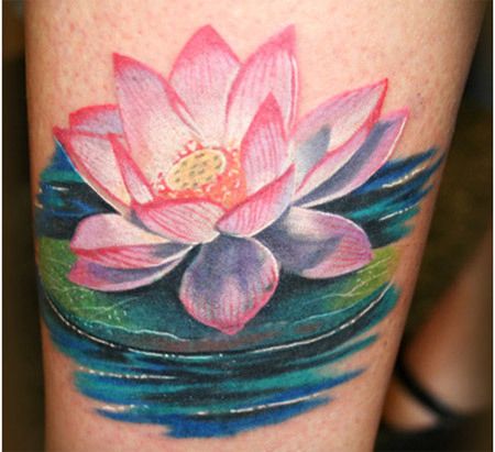 Lotus flower symbolizes realism and this tattoo shows a big lotus flower in pink ink. The pink lotus flower has red shade in the corner which is giving texture to the tattoo. The tattoo also shows blue water and green stems which makes it more realistic. Pink Lotus Tattoo, Water Lily Tattoo, Lotusblume Tattoo, Water Lily Tattoos, Lotus Flower Tattoo Design, Buddhist Tattoo, Lotus Tattoo Design, Water Tattoo, Muster Tattoos