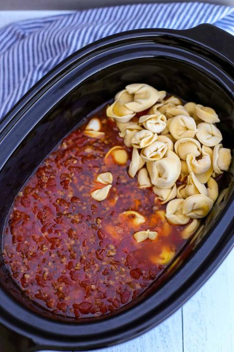 Adding frozen tortellini to the soup in a crock pot. Crockpot Tortellini Soup, Slow Cook Soup, Tortellini Soup With Sausage, Soup In A Crock Pot, Frozen Tortellini, Crockpot Tortellini, Soup With Sausage, Sausage Tortellini Soup, Cheese Tortellini