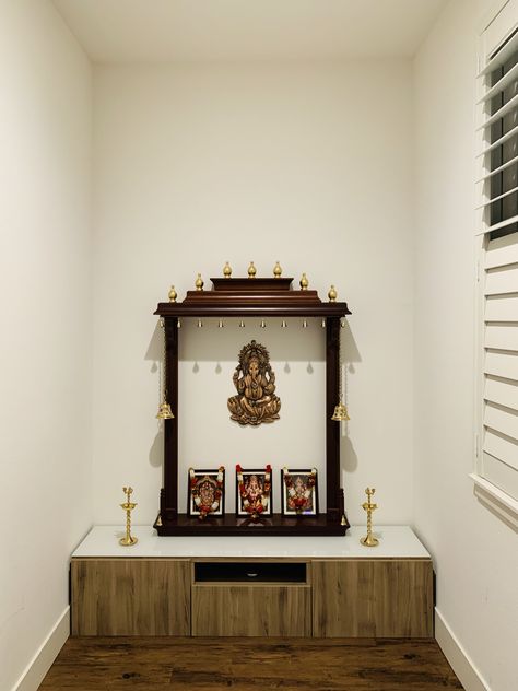 Open style mandir. Bottom drawer is from ikea besta. Top gopuram is assembled from floating shelves purchased from lowes(allen-roth). Vertical columns are made out of crown molded wood and stained with Varathane(cognac color) wood stain from Home depot. Crowns are also from lowes spray painted with metallic gold (rustoleum) from Home depot. Try this yourself. Floating Pooja Unit, Floating Shelves Mandir, Ikea Pooja Mandir, Gopuram Designs For Pooja Room, Open Mandir In Living Room, Pooja Table Ideas, Ikea Besta Top, Color Wood Stain, Pooja Cabinet