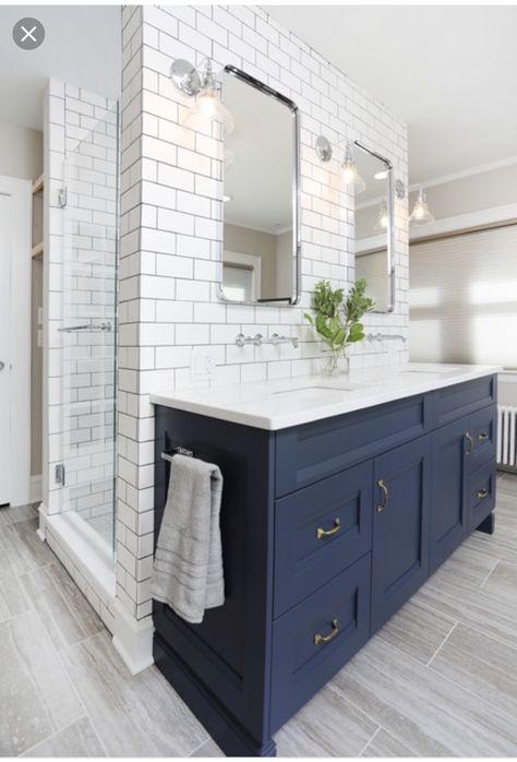 Example of a mid-sized transitional master white tile and ceramic tile porcelain floor and gray floor alcove shower design in Chicago with recessed-panel cabinets, blue cabinets, beige walls, an undermount sink, engineered quartz countertops, white countertops and a hinged shower door. By Normandy Remodeling  #bathroomremodel Navy Farmhouse Bathroom, Flooring Bathroom, Navy Blue Bathrooms, Blue Bathroom Vanity, Blue Vanity, Transitional Bathroom, Blue Cabinets, Bath Ideas, Upstairs Bathrooms