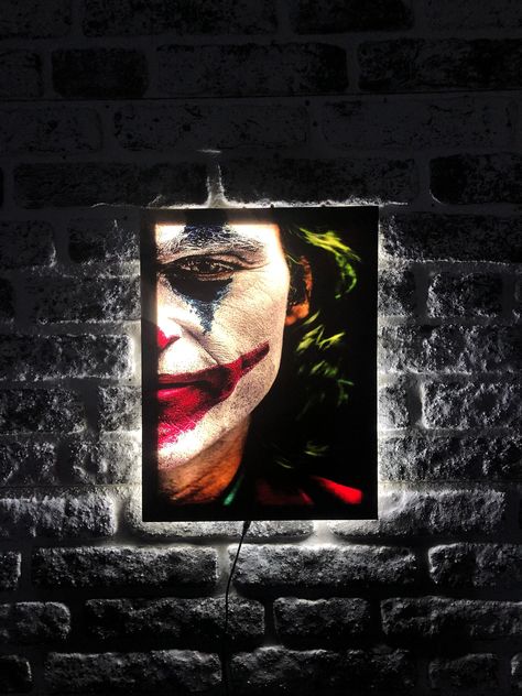 "Joker Special Design LED Lighted Canvas Painting - Illuminate Your Home Decoration!\"  ☆ This handmade and specially designed canvas painting is designed to add a unique atmosphere to your home.  ☆ High quality canvas, durable wooden frame and energy-saving LED lights.  ☆ LED lights are specially designed to add a warm and stylish atmosphere to your environment.  ☆ You can present a special gift to your loved ones by personalizing this canvas painting.\" - \"An excellent option to make your loved ones happy on special days or special moments. You can reach us via message for your personalized orders.\"  ☆ Same day shipping with fast and reliable delivery.  ☆ Package Content: LED canvas painting, adapter.  ☆ Assembly instructions.\" - \"Installation is very easy.  Start using it immediatel Lighted Wall Art, Joker Canvas, Gifts For Him Christmas, Room Decor Gifts, Led Wall Art, Gamer Room Decor, Illuminated Signs, Wall Art Lighting, Gamer Room