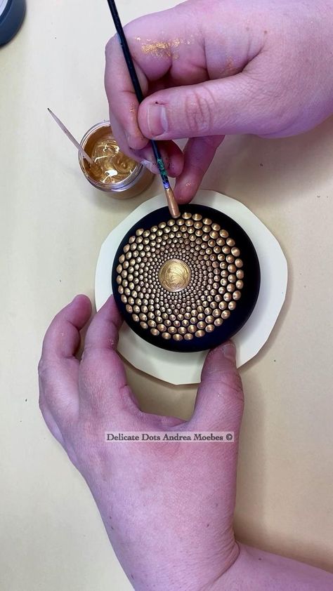 Gold sacred geometry dot mandala stone painting by Delicate Dots Andrea Moebes in 2022 | Stone art painting, Dot art painting, Rock painting patterns Dot Painting Tools, Mandala Painted Rocks, Diy Rock Art, Mandala Rock Art, Stone Art Painting, Mandala Art Therapy, Mandala Design Pattern, Mandala Art Lesson, Painted Rocks Diy