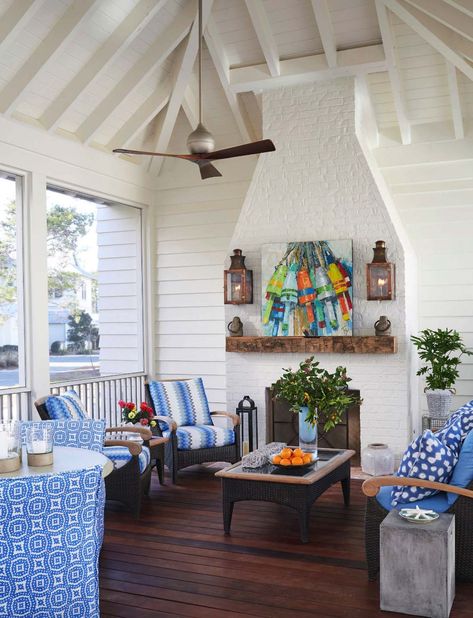 Inviting Beach House-TS Adams Studio-14-1 Kindesign Southern Beach House, Cottage Sunroom, Beach House Getaway, Coastal Fireplace, White Brick Fireplace, Florida Family Vacation, Fireplace Outdoor, House Of Turquoise, White Fireplace