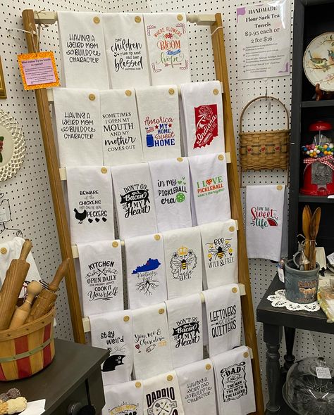 📣 ✨New pricing on my handmade flour sack tea towels means more value for you! I know times are tight right now for everyone including my family. So right now, I am offering handmade flour sack tea towels at a great price of $9.95 each or 2 for $16 in my booth (46, Aisle C) over ar Vendors Village in Clarksville. You’ll also find them for $9.95 in my Etsy shop and at Chosen Goods in Sellersburg (with the exception of my Derby towels). Do you like funny or sweet sayings? I like to hear p... Retail Towel Display Ideas, Craft Show Towel Display, Towel Display Ideas Craft Fairs, Tea Towel Display, Towel Display, Tea Display, Sweet Sayings, Funny Tea Towels, Visual Merchandising Displays