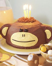 An animal theme can really get things swinging at a kid's birthday party. Indulge your child's penchant for monkey business with a fanciful banana cake with chocolate buttercream icing shaped and decorated to look like a curious friend. Monkey Birthday Cakes, Tårta Design, Torte Creative, Chocolate Buttercream Icing, Monkey Cake, Martha Stewart Recipes, Monkey Birthday, Torte Cupcake, Monkey Face