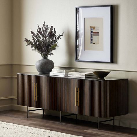 Available online only. Ships directly from the vendor. Immerse yourself in the elegance of the Fletcher Media Console. Crafted from brown oak, its rich texture and linear design are accentuated by reeding details. Four doors adorned with brushed brass hardware and curved corners add sophistication. The top, a slab of bluestone, creates a striking material mix, enhanced by white mineral lines and natural variations, ensuring each piece is unique. Whether in a living room or entertainment area, this console combines style with functionality. Elevate your home entertainment experience with the Fletcher Media Console, where timeless design meets impeccable craftsmanship for a truly captivating centerpiece. Bluestone top Four doors Brushed brass hardware Curved corners Interior shelving Weight: Oak Media Console, Oak Tv Stand, Brushed Brass Hardware, Living Room Bench, Storage Credenza, Tv Stands And Entertainment Centers, Four Hands, Media Console, Living Room Tv