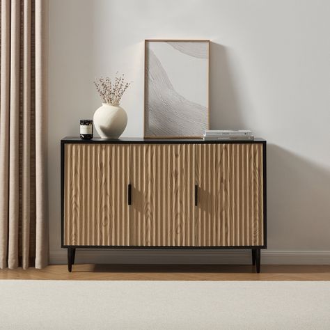 A true statement of style for any modern or classic interior, take a look at the Evie large sideboard in black and wood effect. Smart stylish storage for your home essentials The Evie 3 Door Sideboard is a stunning blend of style and versatility. Delivered to your home flat packed, the Evie Sideboard is both durable and functional, providing the perfect place for all your home essentials. With a beautifully designed symmetrical ridged detail and smooth curved lines, it also has a matte painted finish in black with matching legs and handles for a seamless look. Explore the collection Mix and match throughout your home or treat yourself to the entire collection, which includes 2 Drawer Bedside Table 3 Drawer Chest 6 Drawer Chest Small Sideboard Large Sideboard TV Stand Also available in warm Tv Stands Uk, Sideboard With Drawers, Japandi Bedroom, Chest Bedside Table, Stylish Sideboards, Room Styling, Small Sideboard, 6 Drawer Chest, Black Sideboard