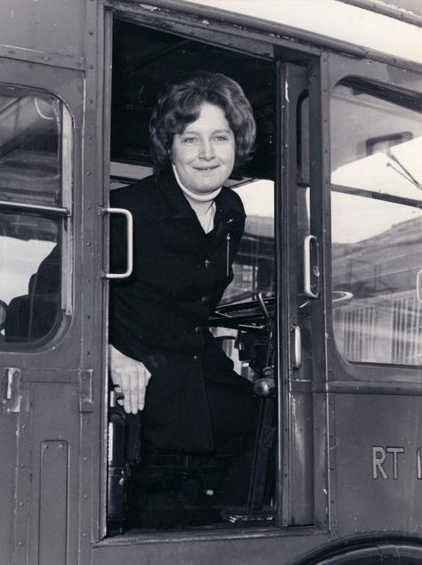 B/W print; bus driver Jill Viner in the cab of an RT-type bus, May 1974 | London Transport Museum Rt Bus, 19th Century London, Underground Shelter, London Transport Museum, The Cab, How To Lean Out, The Blitz, Red Bus, London Transport