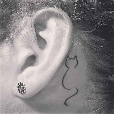 25 Best Small Cat Tattoo Designs - The Paws Cat Tattoo Behind Ear, A Cat Tattoo, Tiny Cat Tattoo, Minimalist Cat Tattoo, Cat Outline Tattoo, Behind Ear Tattoos, Tattoo Behind Ear, Cat Tattoo Simple, Cute Cat Tattoo